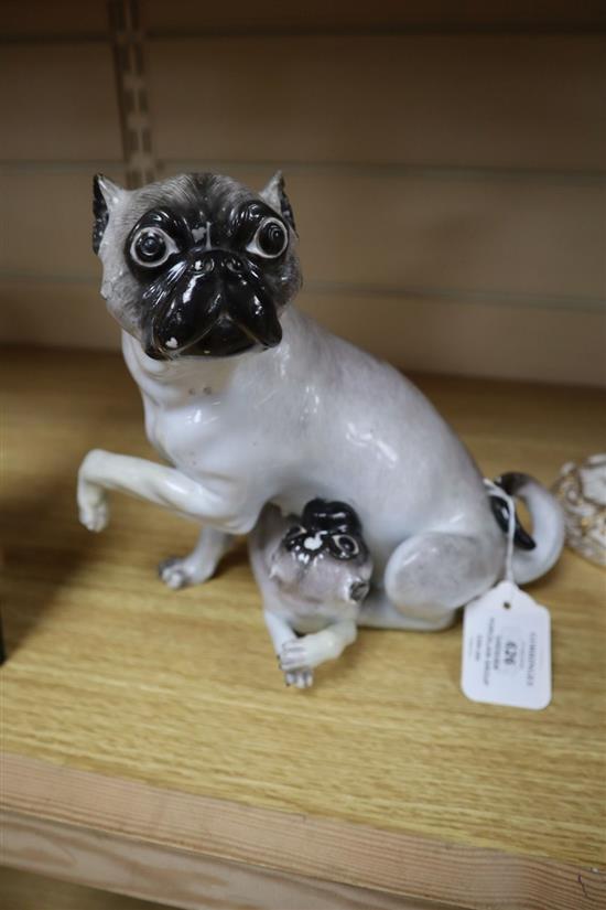 A Dresden porcelain group of a pug and puppy, 19th century, height 21cm